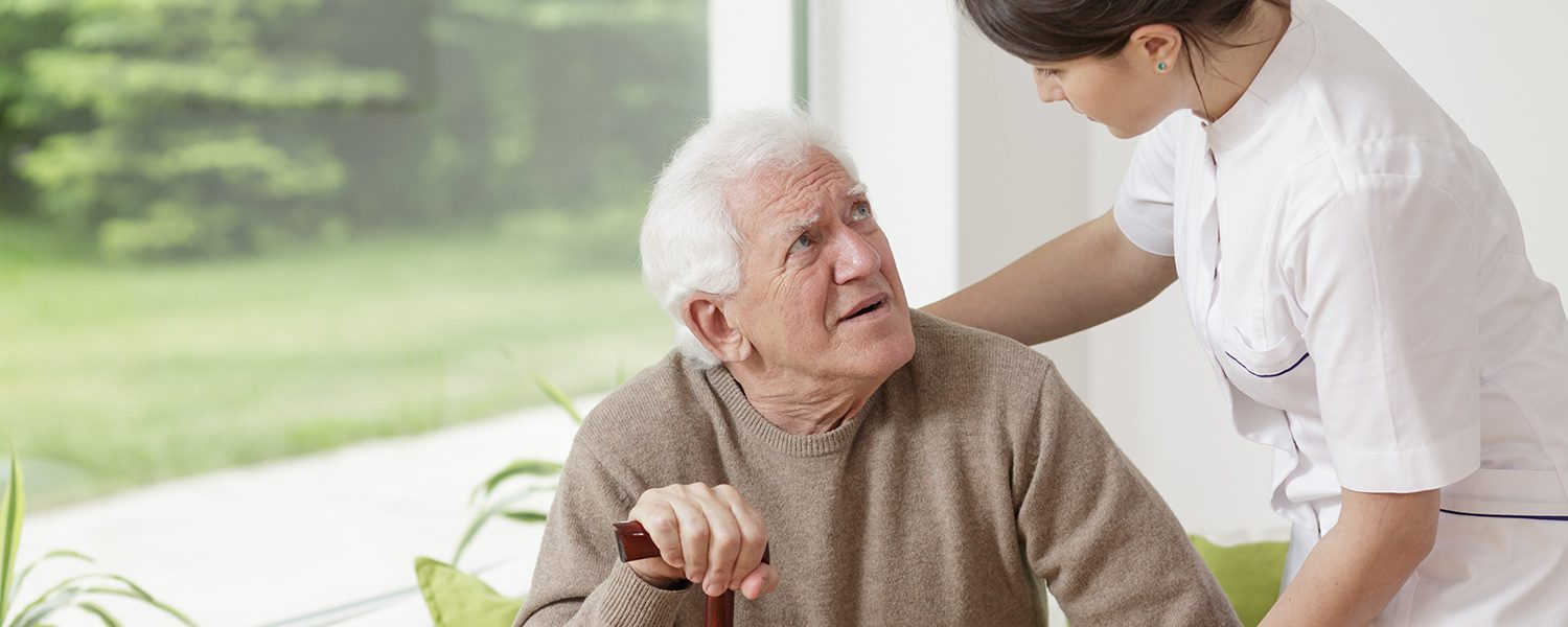 Nurse helping an elderly man